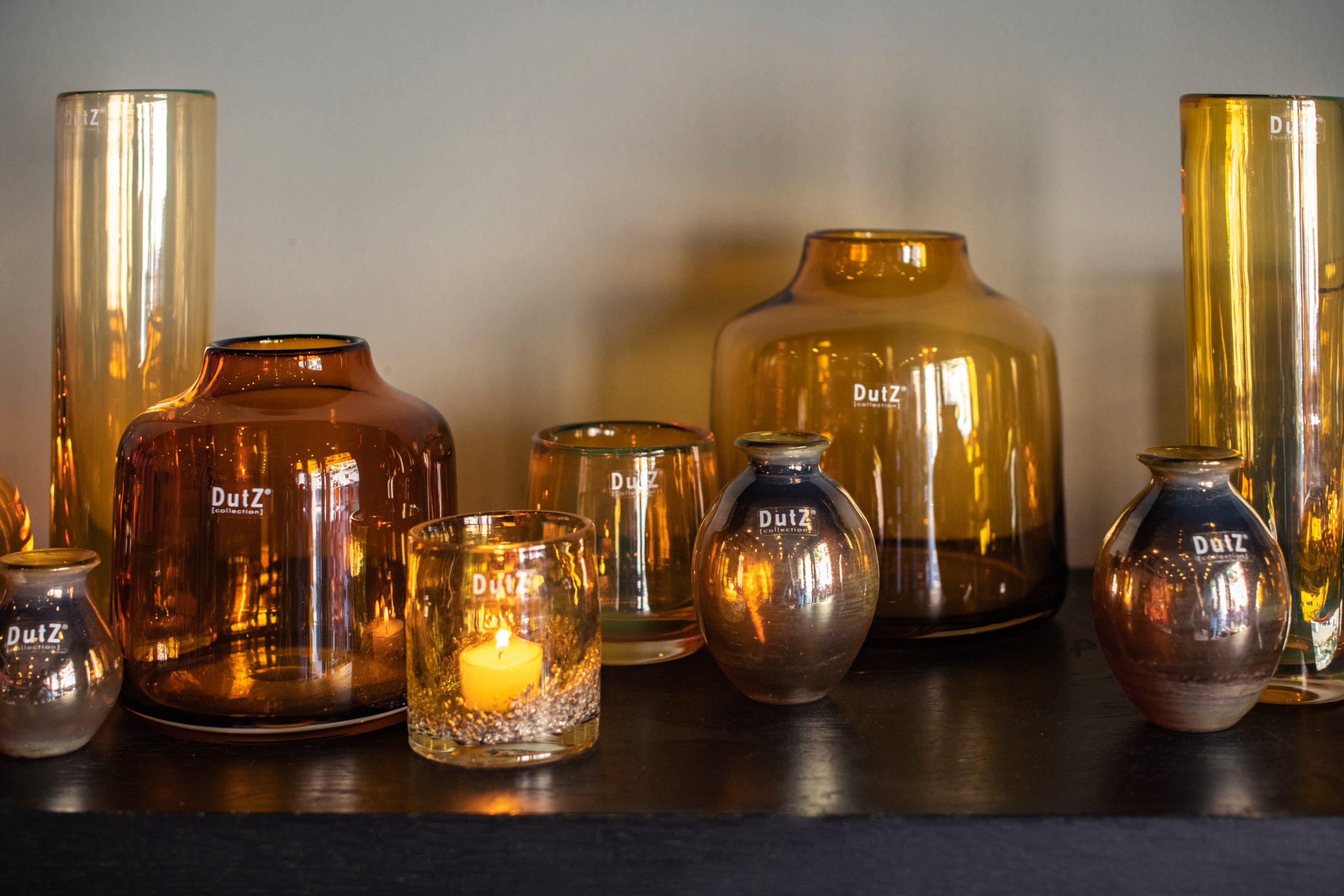 Several gold coloured glassvases on a table